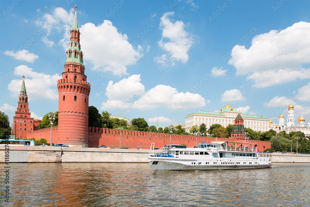 Passenger boat goes across Moscow river in Moscow Kremlin