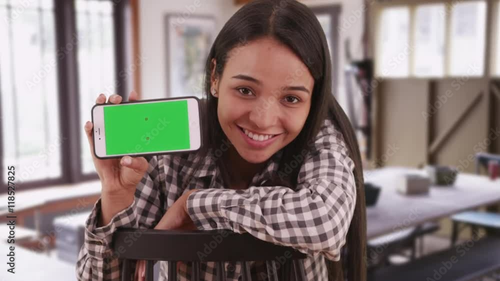 Mexican woman student holding smartphone with green screen Mexican woman student holding smartphone with green screen
