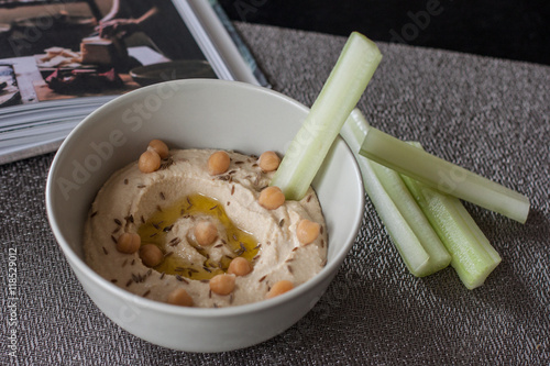 Hand-made hummus and fresh selery sticks photo