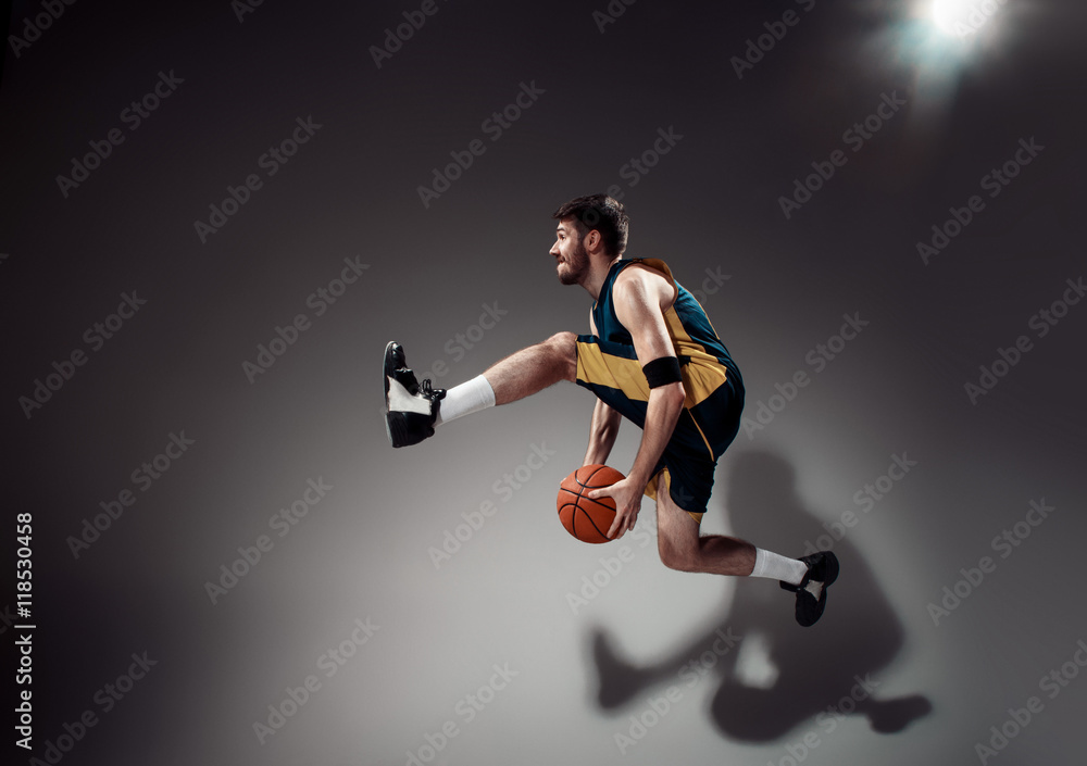 Full length portrait of a basketball player with ball