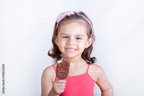 Young girl feeling happy while eating chocolate ice cream bar