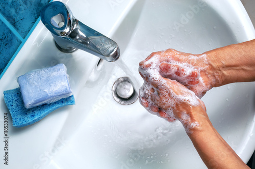 soapy hand over the washbasin photo
