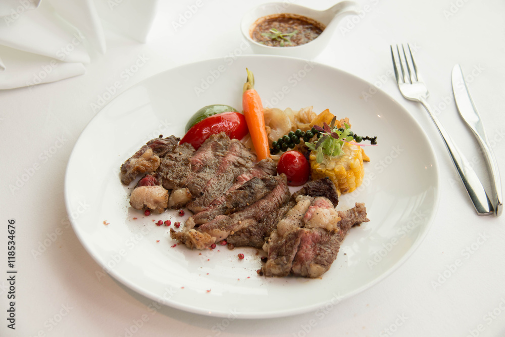 cooked rare sirloin steak on a white plate cooked rare sirloin steak on a white plate
