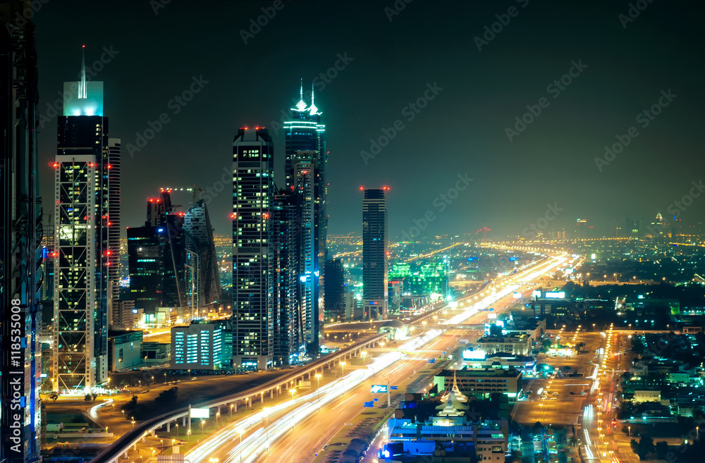 Amazing night dubai downtown skyline with tallest skyscrapers and road leading to Abu Dhabi during rush hour, Dubai, United Arab Emirates