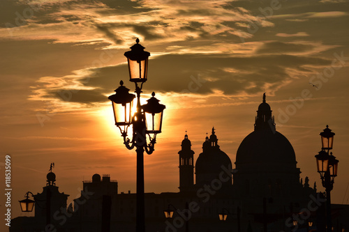 Sunset over Salute Basilica domes in Venice lagoon