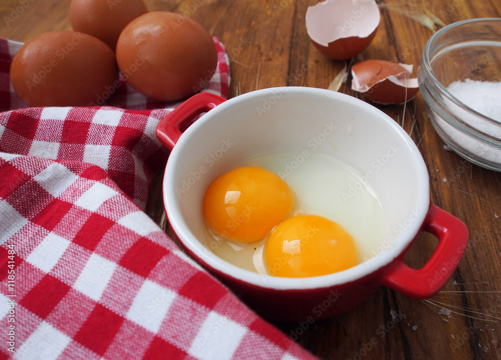 Raw eggs in red and white bowl Raw eggs in red and white bowl