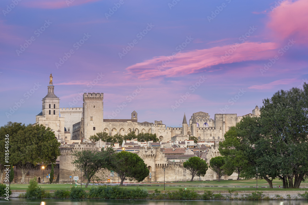 The Palais des Papes with a colored cloudy sky