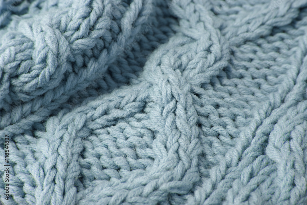 A full page close up of pastel blue knitted sweater fabric texture A full page close up of pastel blue knitted sweater fabric texture