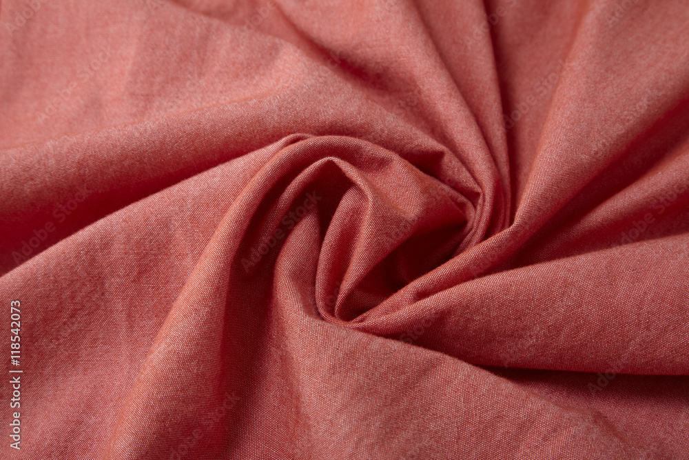 A full page close up of a swirl of brick red shirt fabric texture A full page close up of a swirl of brick red shirt fabric texture