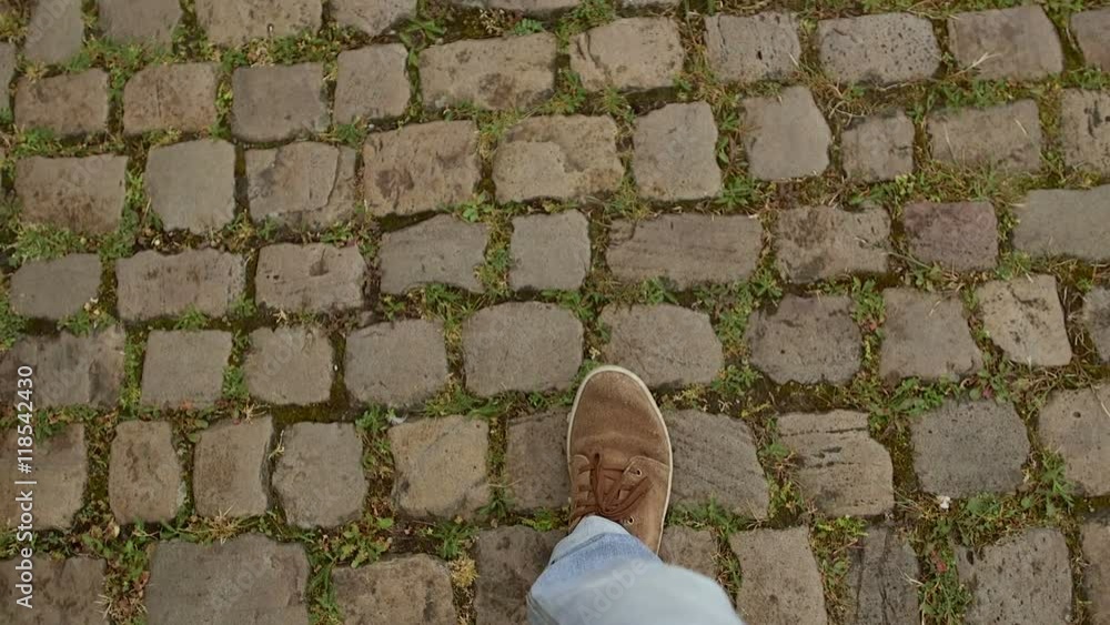 Man walking on the pavement. View from above Man walking on the pavement. View from above