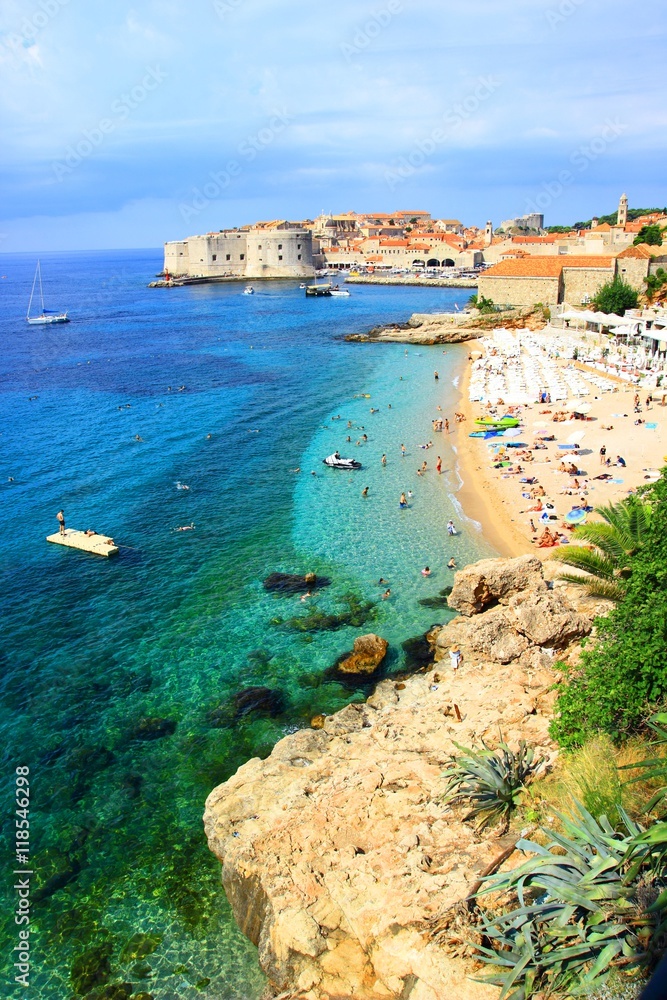 Fototapeta premium Coast, sea and beautiful beach Banje with Dubrovnik old town in background in Croatia 