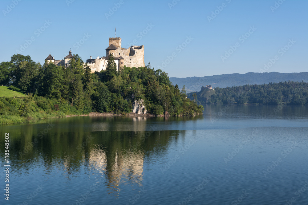 A beautiful view of medieval Dunajec castle in Niedzica village in the morning. Czorsztyn castle in background. Poland. Europe. A beautiful view of medieval Dunajec castle in Niedzica village in the morning. Czorsztyn castle in background. Poland. Europe.