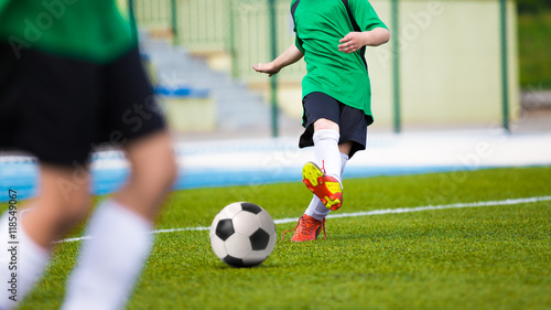 Football soccer kick. Young player kicking soccer ball
