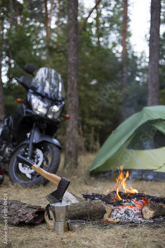 Camping in the woods bike standing next to the tent.