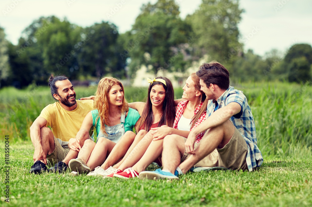 group of smiling friends talking outdoors