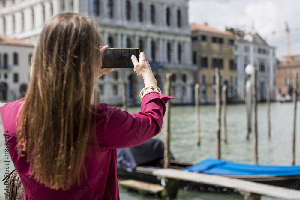 Italy, Venice, tourist taking pictures with smartphone Italy, Venice, tourist taking pictures with smartphone