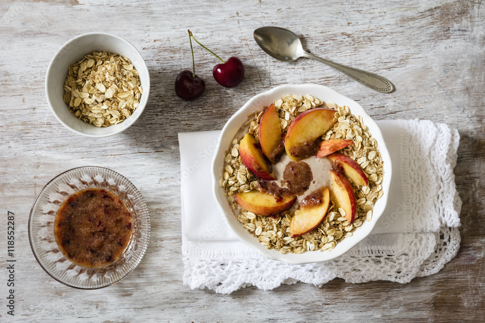 Cherry smoothie bowl with peach and oat flakes, topping Cherry smoothie bowl with peach and oat flakes, topping
