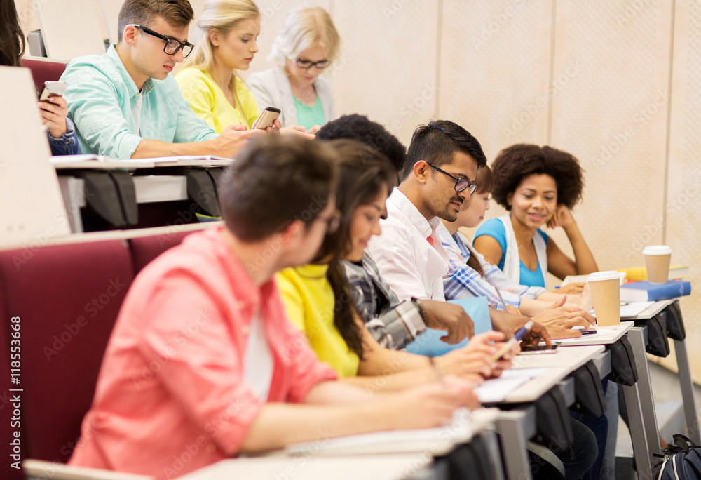 group of students with coffee writing on lecture