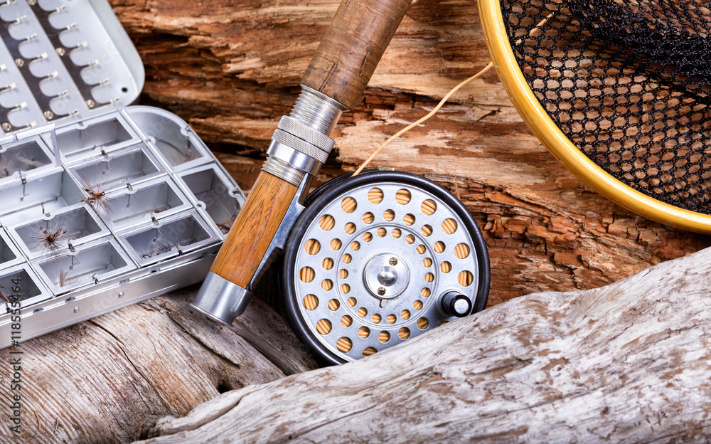 Vintage fly fishing outfit and gear on rocks and wood background Stock  Photo