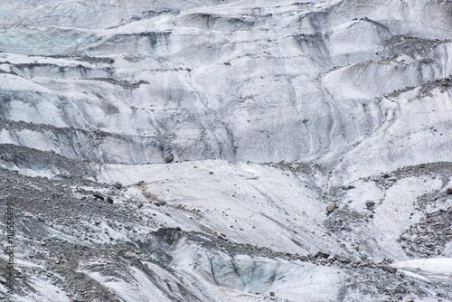 Ice of glacier surface, closeup. Glacial ice nature background. Glacier Chalaadi, the Caucasus. Near Mestia town, Svaneti, Georgia