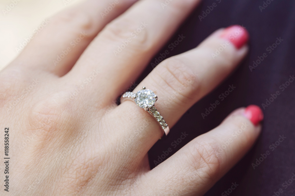 Woman's hand wearing an engagement ring Woman's hand wearing an engagement ring