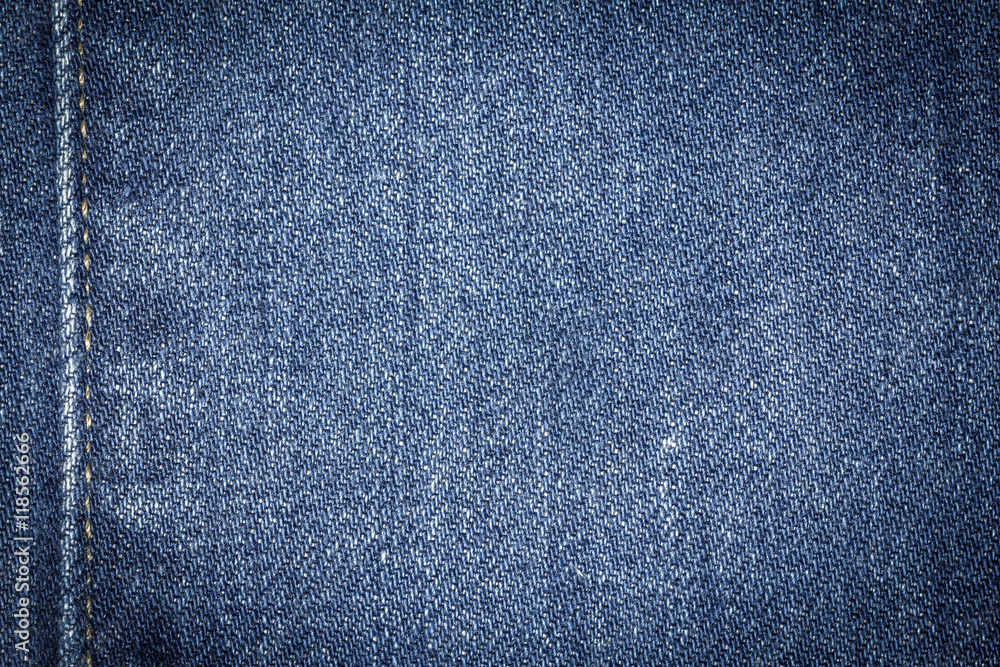 Naklejka premium Denim jeans texture or denim jeans background with seam. Old grunge vintage denim jeans. Stitched texture denim jeans background of jeans fashion design.