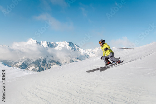 Alpine skier with snowy mountains