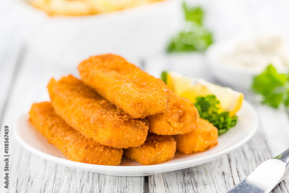Fisch Sticks (close-up shot) on an old wooden table Fisch Sticks (close-up shot) on an old wooden table