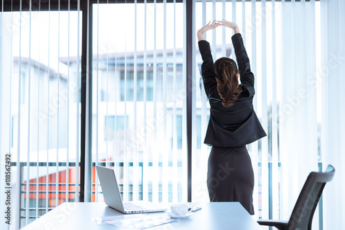 Relaxed Young business woman in office,hi key