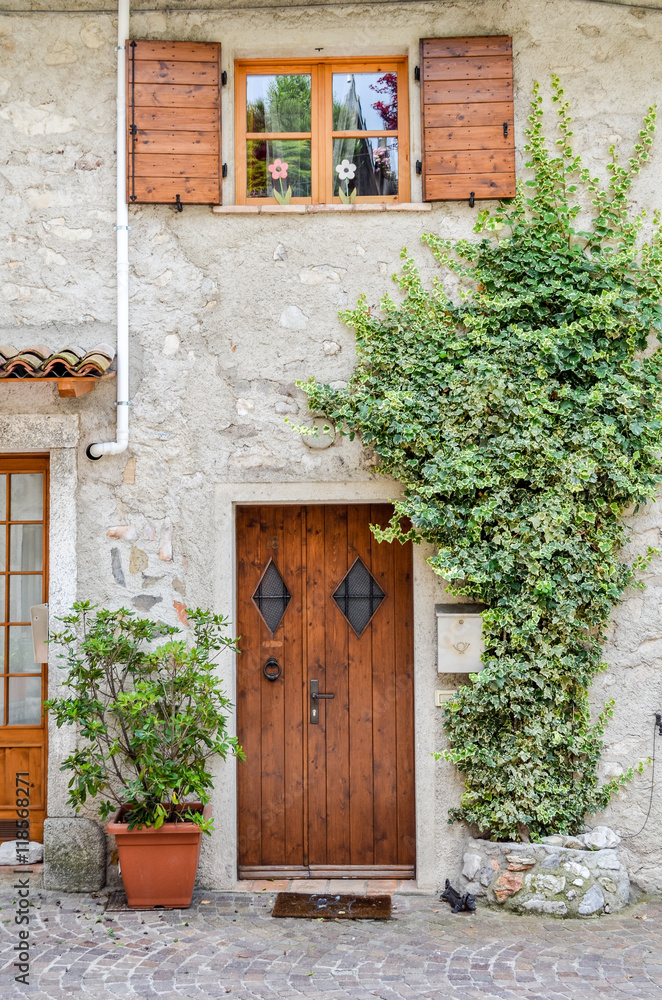 Wooden front door and window in Limone sul Garda, Italy.