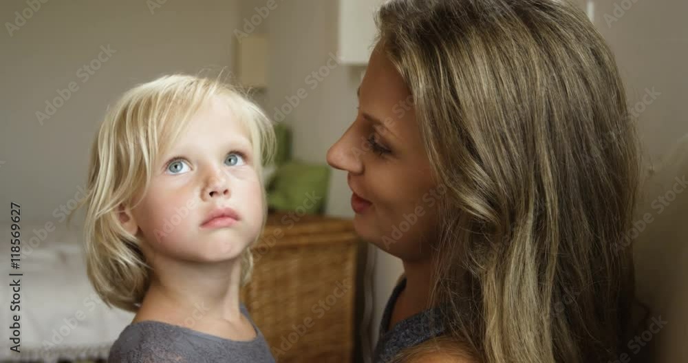 Bright picture of hugging mother and daughter in bedroom, close-up Bright picture of hugging mother and daughter in bedroom, close-up
