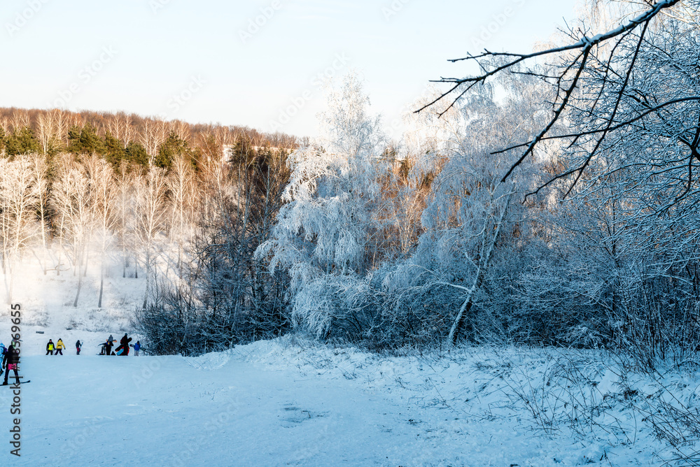 Panorama of the ski resort. Winter landscape. Snowboarders downhill.