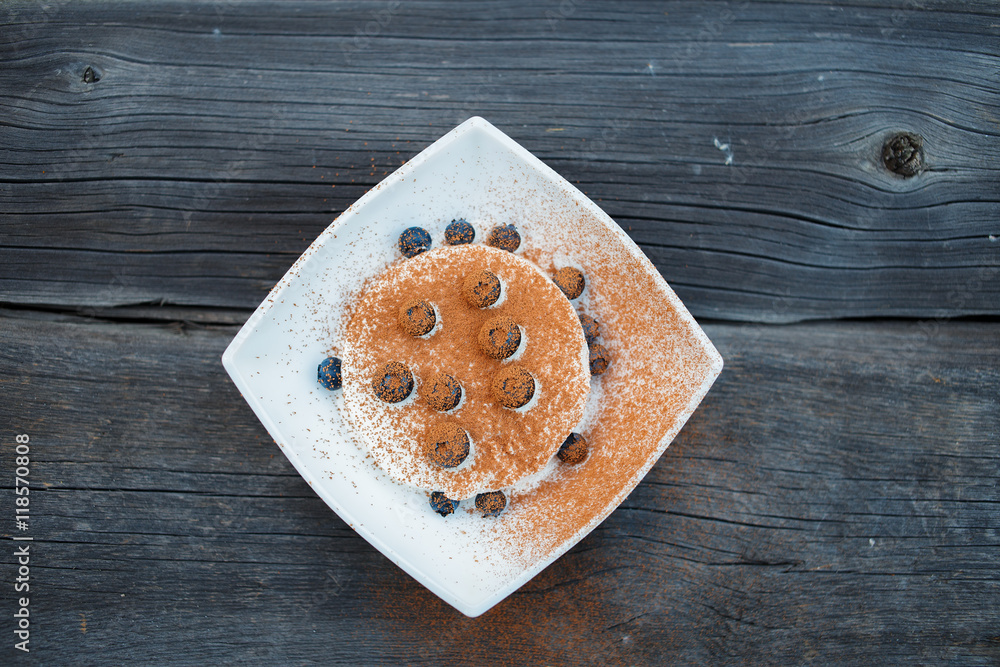Ice cream with blueberries and cocoa powder in white piala Ice cream with blueberries and cocoa powder in white piala