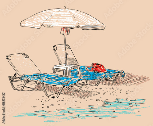 beach umbrella and sunbeds on the seashore