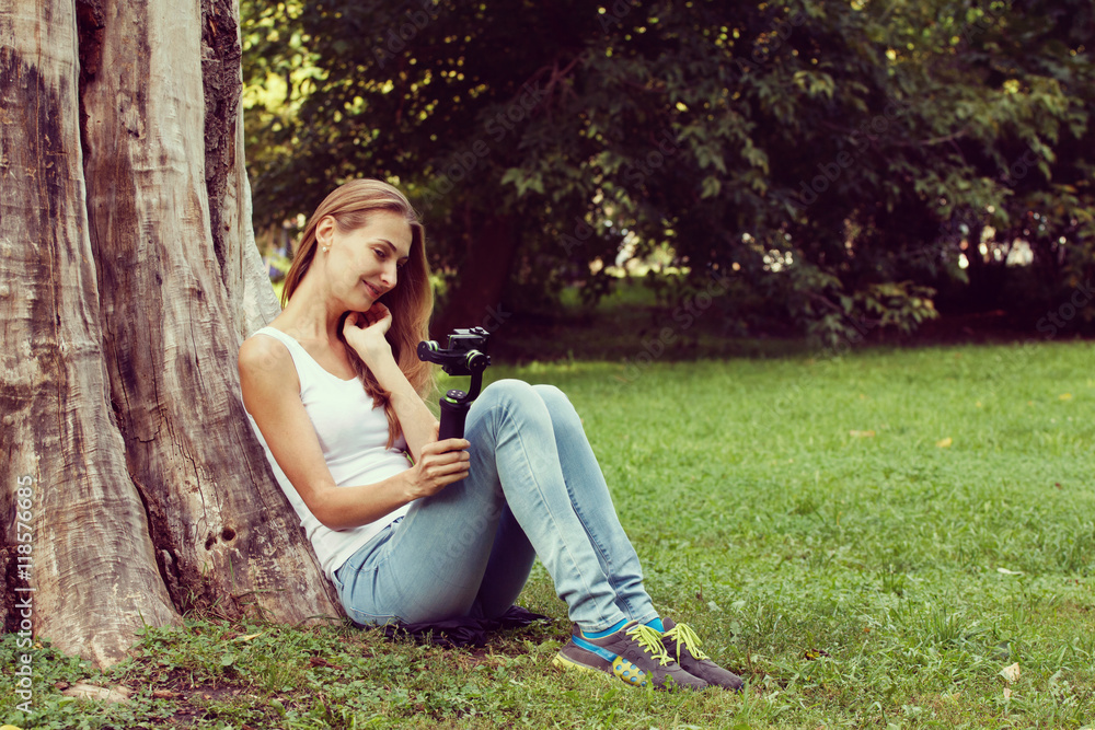 Pretty woman with action camera in her hand. Pretty woman with action camera in her hand.
