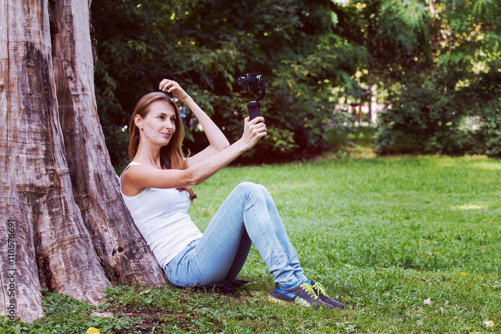 Pretty woman with action camera in her hand. Pretty woman with action camera in her hand.