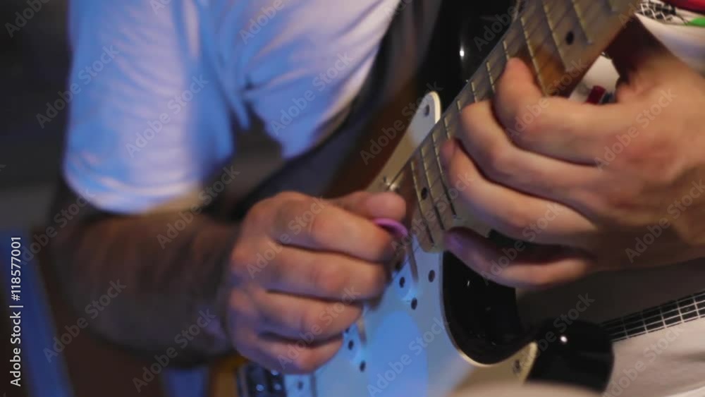 The man playing solo on electric guitar in the recording studio close-up The man playing solo on electric guitar in the recording studio close-up