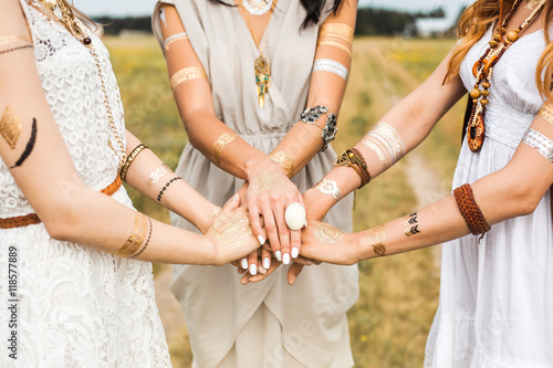 Close-up of female hands, three girls, best friends, flash tattoo, accessories, Bohemian, boho style, indie hippie, ring, bracelet, manicure, feathers photo