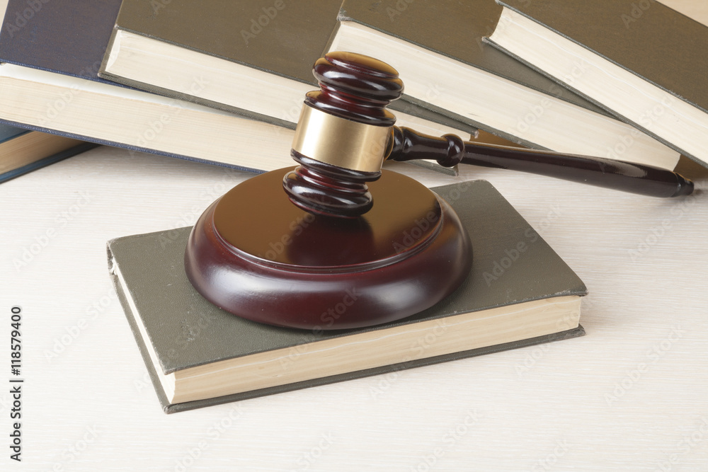 Law concept - Book with wooden judges gavel on table in a courtroom or enforcement office. Law concept - Book with wooden judges gavel on table in a courtroom or enforcement office.