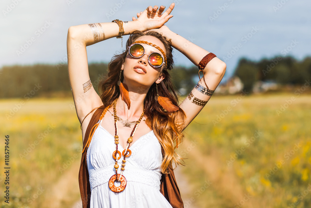Pretty amazing free red-haired hippie girl dancing outdoors, feathers and braids in her hair, white dress, vest with fringe, accessories, sunglasses, tattoo flash, indie, Bohemian, boho style - obrazy, fototapety, plakaty 