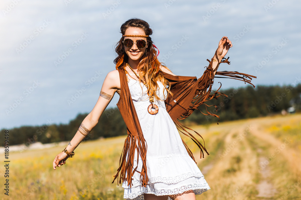 Pretty amazing free red-haired hippie girl dancing outdoors, feathers and  braids in her hair, white dress, vest with fringe, accessories, sunglasses,  tattoo flash, indie, Bohemian, boho style Stock Photo | Adobe Stock