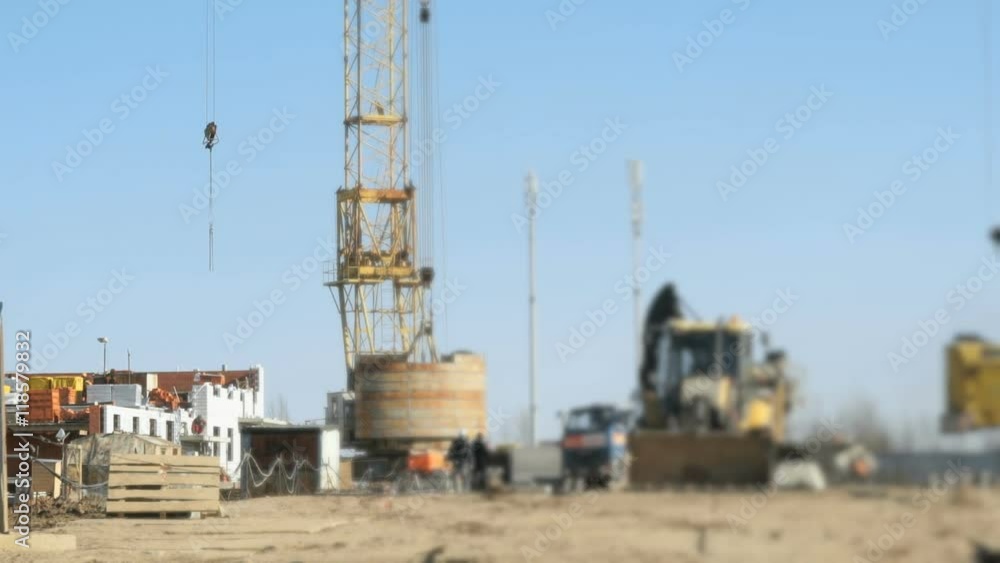 Workers work on construction of building outdoors Workers work on construction of building outdoors