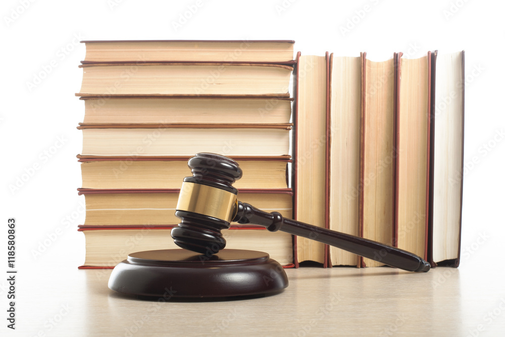 Law concept - Book with wooden judges gavel on table in a courtroom or enforcement office. Law concept - Book with wooden judges gavel on table in a courtroom or enforcement office.