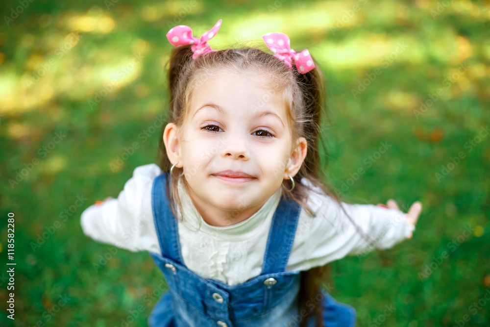 Sweet little girl outdoors with curly hair in two long tails, closeup portret. Sweet little girl outdoors with curly hair in two long tails, closeup portret.