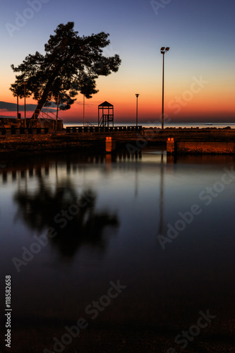 Reflection of the tree and tower in the marina in Poreč, Croatia