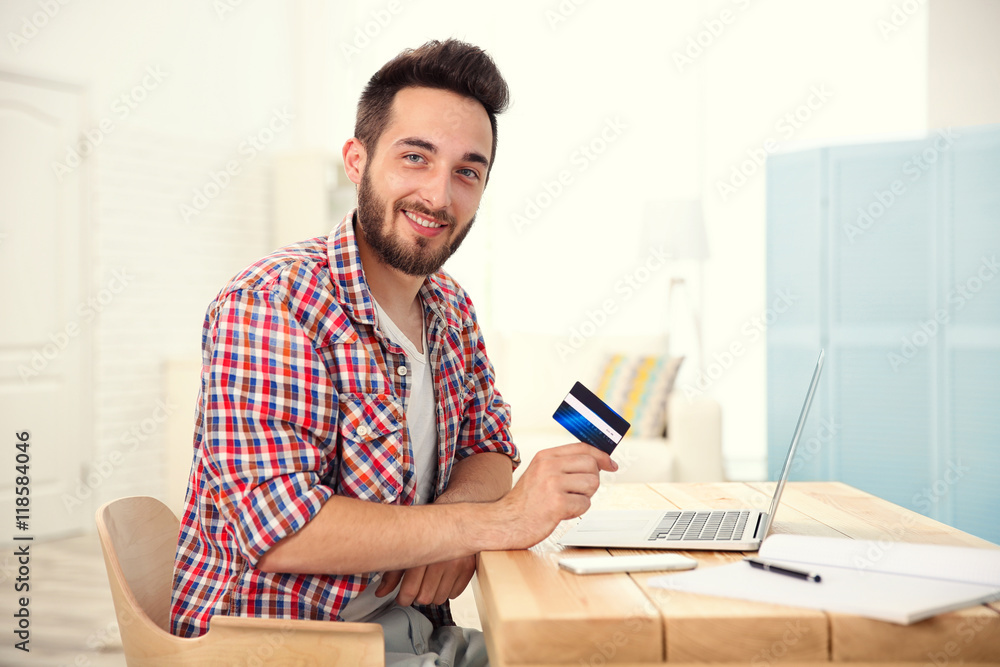 Man using credit card and laptop for online shopping Man using credit card and laptop for online shopping