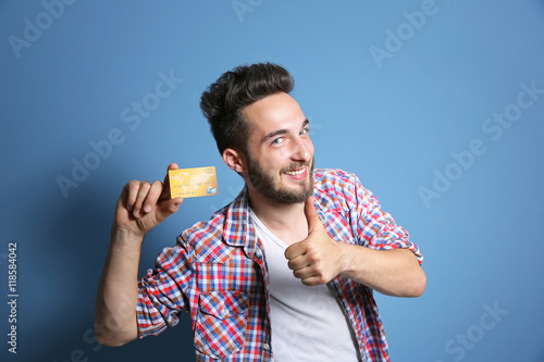 Young man holding credit ca...