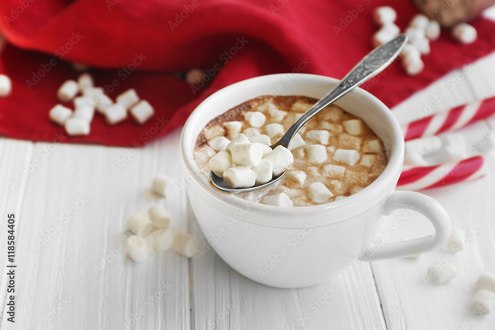 Cup of hot chocolate with marshmallows and candy on table Cup of hot chocolate with marshmallows and candy on table