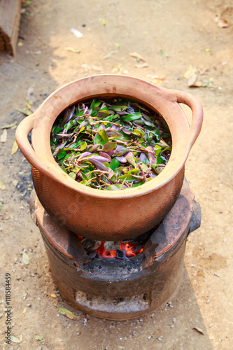 decocting medicinal herbs with earthen pot   © thirathat