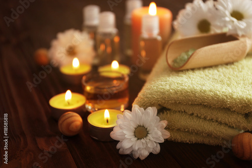 Beautiful spa set with flowers on wooden table